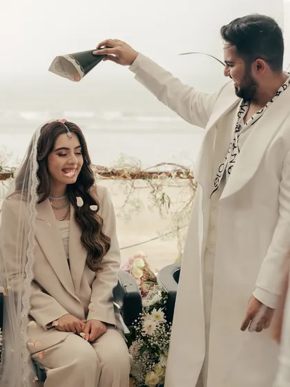 A playful moment during their beach ceremony. These lighthearted, fun interactions are just as important as the solemn vows, as they show the true personality of the couple.