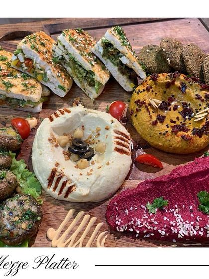 My classic Mezze Platter is a journey to the Mediterranean. It features creamy hummus, beetroot hummus, crispy falafel, pita bread, and marinated mushrooms.