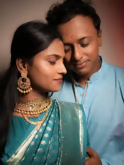 An intimate pre-wedding or engagement shoot portrait, with soft lighting creating a romantic mood.