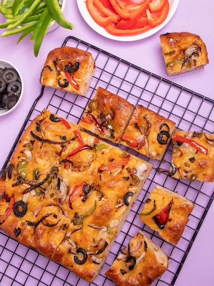 My signature Garden Focaccia is topped with onions, peppers, and olives, creating a beautiful and delicious bread. I also offer a multigrain option.
