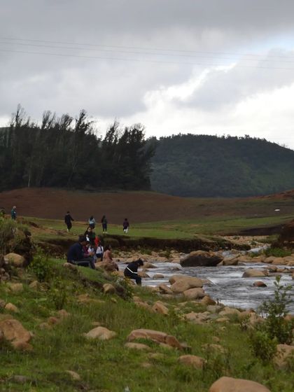 A wider view of our group enjoying the riverside scenery. It shows the scale of the beautiful, natural landscapes we visit.