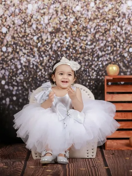 This full-length shot showcases the beautiful tutu dress and the complete vintage-glam setup, perfect for a special milestone or just-because photoshoot.