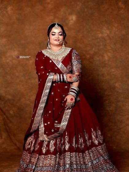 A full length portrait showcasing the grandeur of the bridal attire. The neat updo is essential for balancing the look and ensuring the bride's features are highlighted.