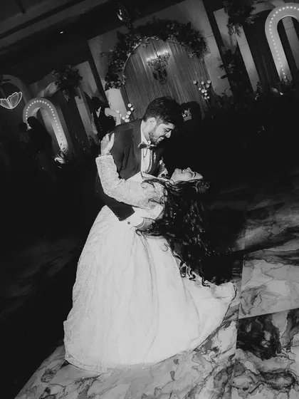 The first dance, captured in dramatic black and white. The dip and the flow of the bride's hair create a sense of movement and romance, a truly cinematic moment.