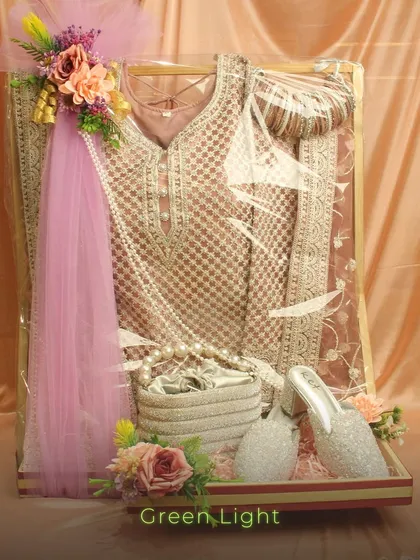 Playing the gifting game like a pro means paying attention to every detail. Here, a complete bridal outfit with matching shoes and a purse is elegantly packed in a display tray, ready to be presented as part of the wedding trousseau.