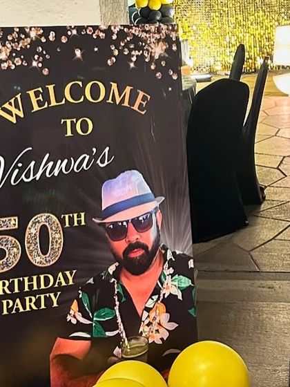 A personalized welcome sign for the 50th birthday bash, featuring a cool photo of the guest of honor.