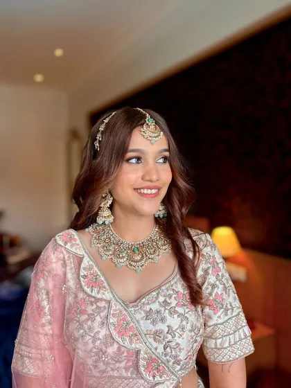 A beautiful portrait of the bride's sister. Her makeup is radiant and her smile is bright, capturing the happiness of the day.
