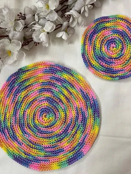 A beautiful pastel rainbow spiral pattern is featured in these two doilies. The softer color palette offers a different take on the popular rainbow theme.