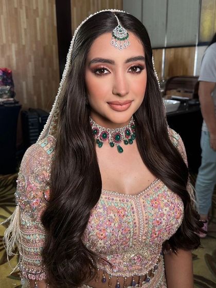 A fairytale bridal look with soft, open waves under a delicate veil.