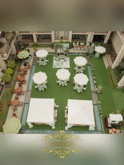 An aerial view of the tropical Mehndi setup, showing the layout of the cabanas, umbrellas, and stage in the courtyard.