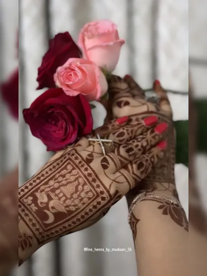 An artistic shot of a back-hand design with swan motifs, held with roses.