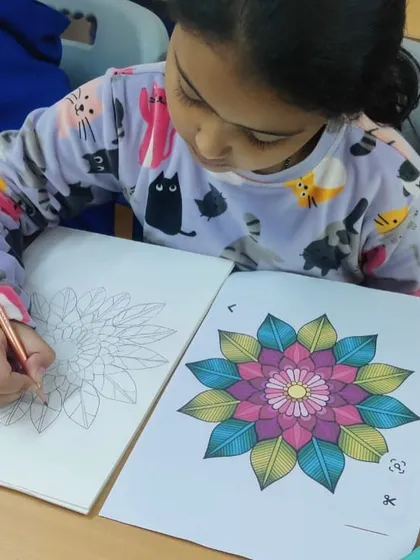 A student works on a beautiful mandala coloring sheet. This activity is not only creative but also very calming and helps improve focus.