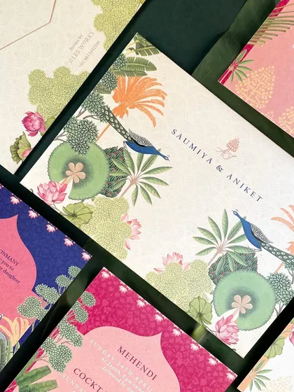 The main folder for the suite, featuring a stunning illustration of peacocks amidst a lush garden of lotus flowers and palm trees. This piece sets a grand and artistic tone for the entire wedding.