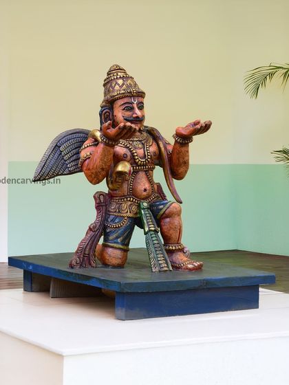 A colorful sculpture of Garuda, the divine eagle vahana of Lord Vishnu. This piece is often placed in front of a Vishnu or Balaji idol and is handcrafted with vibrant details.