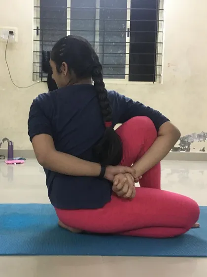 This student is in an advanced shoulder twisting asana. Twisting poses are excellent for spinal health and flexibility.