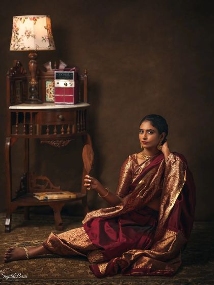 A woman sits on the floor, holding a hand mirror, next to a vintage radio. This portrait is rich with nostalgia and storytelling elements, creating a scene that feels like a memory from the past.