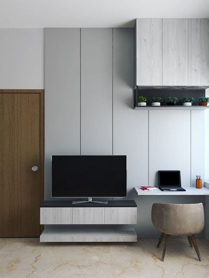 This 3D render shows a compact bedroom design with a multipurpose unit that combines a TV console, a study table, and storage. The vertical grooves on the wall panel add a sense of height to the room.