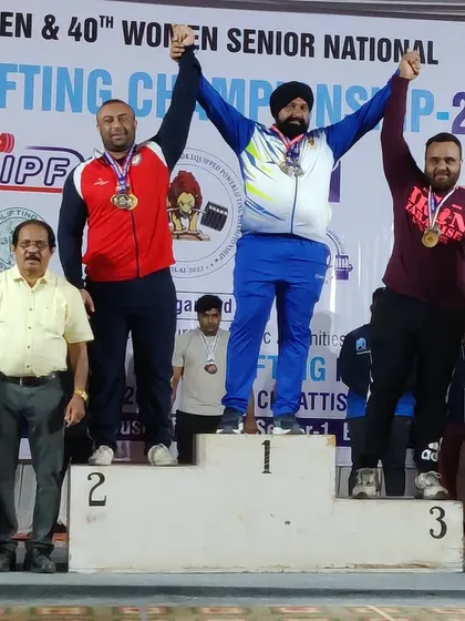 On the podium with an overall silver medal at the 2022 Senior National equipped powerlifting championship.