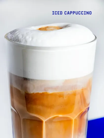 A close-up of our Iced Cappuccino, showing the thick, rich foam that sits atop the chilled espresso and milk.