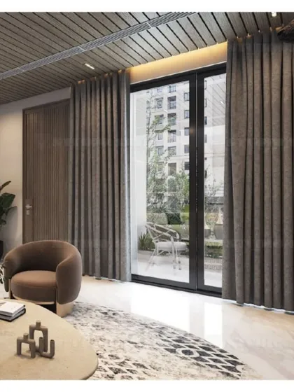 This view shows the connection to the outdoors, with large glass doors leading to a balcony, allowing natural light to fill the living space.