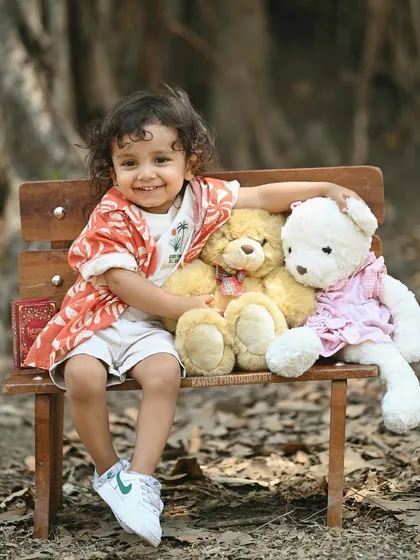 A heartwarming shot of the boy hugging his teddy bear, full of innocence and charm.