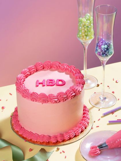 Say "Happy Birthday" with a pop of color! This vibrant pink mini message cake is a fun and modern way to celebrate.