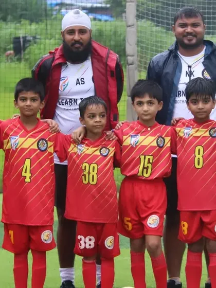 The U9 team with their coaches at the Grassroots Football Fiesta.