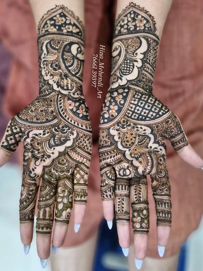 A bold and beautiful engagement mehendi with heavy paisley motifs. The design uses a mix of thick and thin lines to create depth and contrast.