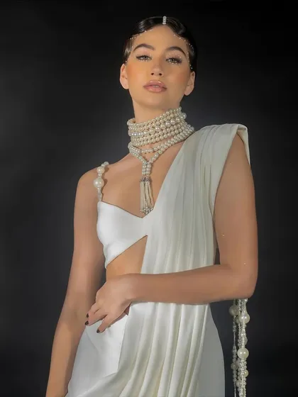 A close-up lookbook shot for Nikhil Thampi. The focus here is on the garment's neckline, the pearl shoulder detail, and the model's beauty look, creating a compelling image for social media and press.