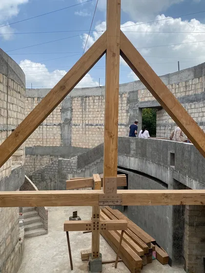 A view from the ground floor of the House of Galleries, looking up at the timber roof trusses being installed.