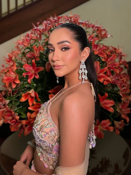 Radiating elegance with a touch of modern chic. This look features a sharp, defined eye and a flawless base, paired with a sleek ponytail.