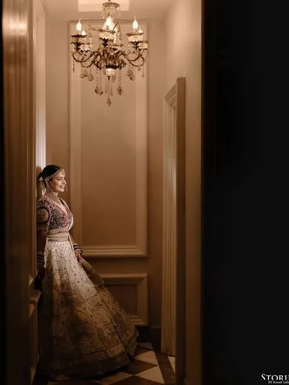 A full-length portrait of the bride in a beautifully lit corridor, showcasing her elegant poise.