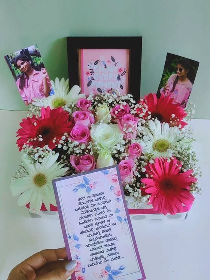 A complete personalized gift set, this image shows the floral box with photos and a handwritten note in Kannada, demonstrating our ability to cater to specific personal requests.