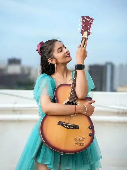 A confident and playful shot, with the model holding her guitar like a rockstar, ready to perform.