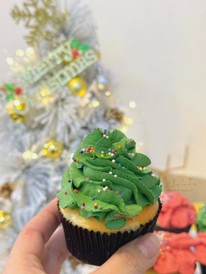A close-up of my Christmas tree cupcake! I piped green frosting in a swirl and added colorful sprinkles to look like ornaments. It's a simple, fun, and delicious holiday treat.
