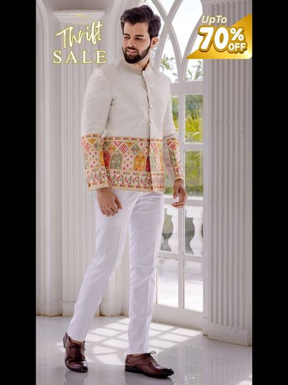 A unique white Jodhpuri-style jacket with colorful embroidery on the sleeves, perfect for a mehendi or sangeet.