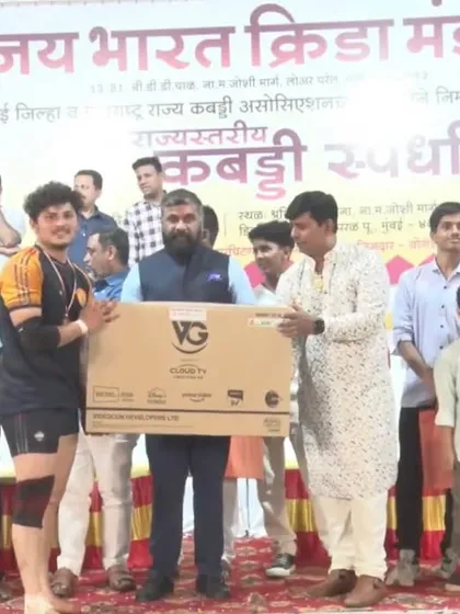 Omkar receiving the 'Best Defender of the Tournament' award, along with a new TV.