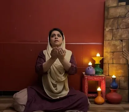 The setting for my performance on Sufi poetry, with candles creating an intimate and spiritual ambiance. The painting in the background adds to the mood.