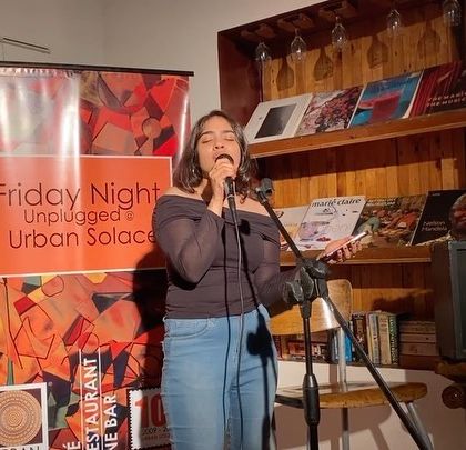 Another shot of a debut performance, capturing the courage and excitement of a first-time performer. Our supportive audience makes it a welcoming experience for everyone.