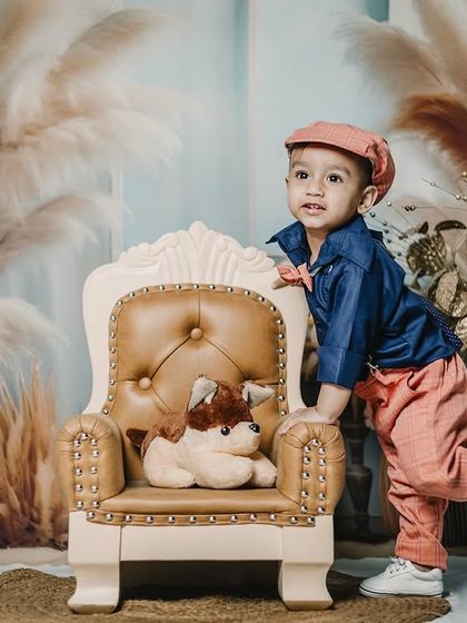 I’m not just cute, I’m also super smart! A playful pose from a stylishly dressed boy in our pampas grass studio.