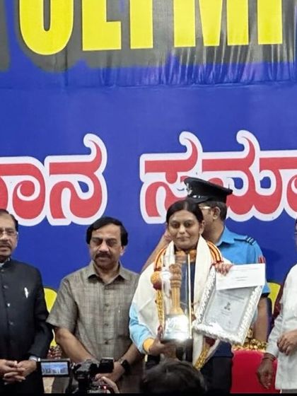 Divya T.S. being felicitated by the Karnataka Olympic Association for her two Silver Medals at the Asian Games, an award presented by the Governor of Karnataka.