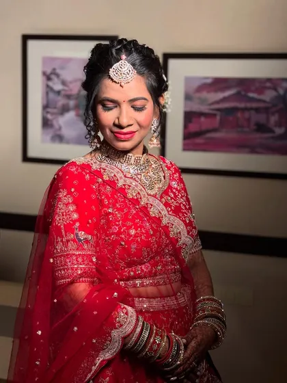 The bride with her eyes closed, showcasing the soft and shimmering eyeshadow work.