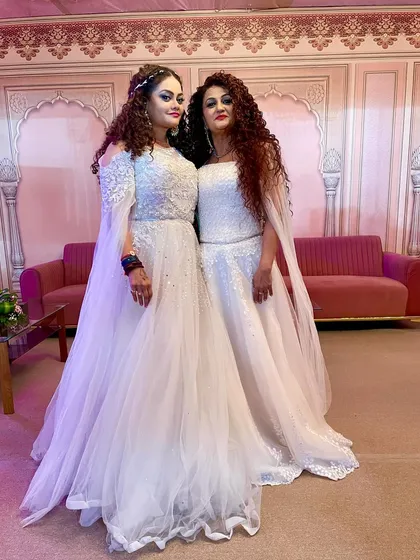Posing backstage in our elegant white outfits. We love capturing these moments before the show begins.