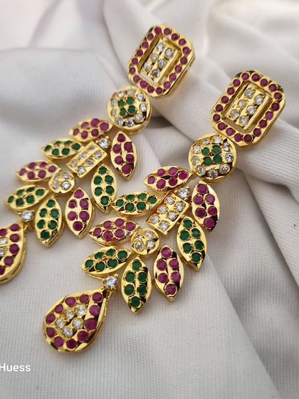 A close-up of the 'चारु' (Charu) earrings against a white background, making the colours pop.