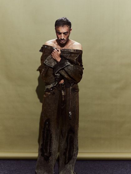 A model in a deconstructed denim jumpsuit. The off-shoulder styling was an intentional choice to give the look a sense of vulnerability.