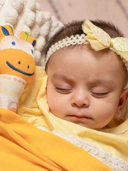 A sweet newborn sleeping in a basket as part of our sunflower and bee theme, showing how I can incorporate themes even for the tiniest clients.
