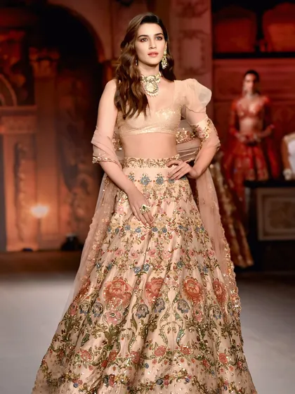 A powerful runway photo of Kriti Sanon. The composition and her confident pose make this a classic shot that showcases both the model and the designer's creation.