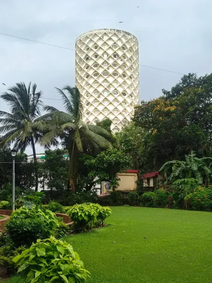 A view of the lush park surrounding the iconic Nehru Centre in Mumbai, a testament to the importance of integrating large-scale public green spaces with institutional architecture.