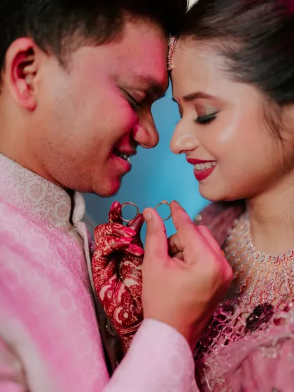 A close-up, intimate shot of the couple holding their engagement rings. I use creative lighting to create a romantic and celebratory mood for these important detail shots.