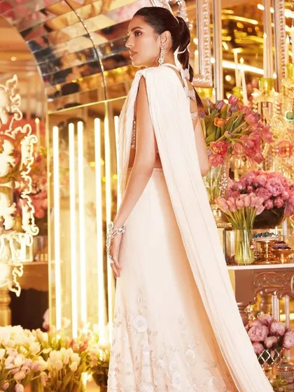The caped detail on this custom Tamara Ralph saree gives it a modern, almost ethereal feel. It’s a true work of art for a very special occasion.